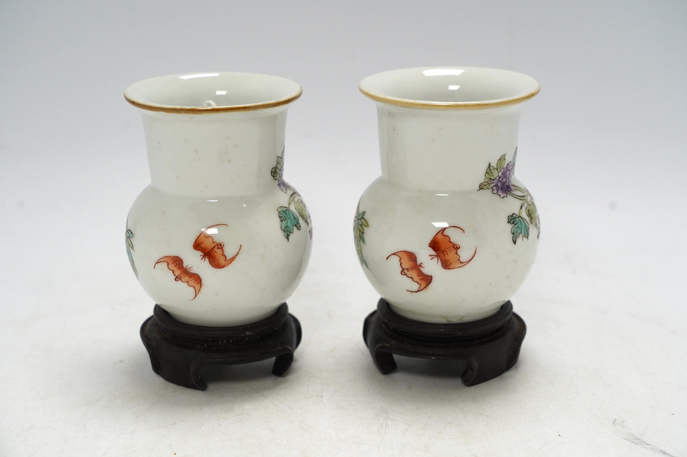 A pair of Chinese famille rose vases, mid 20th century, on wood stands, 10cm high. Condition - good